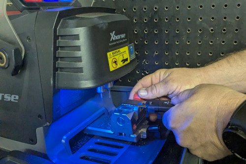 Businesswoman using the key to unlock her car door