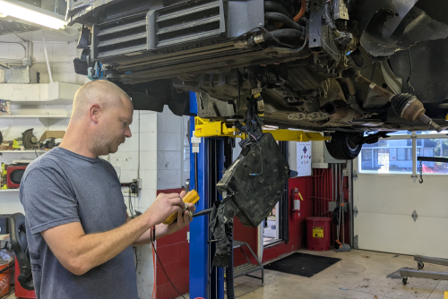 Medium shot man checking car